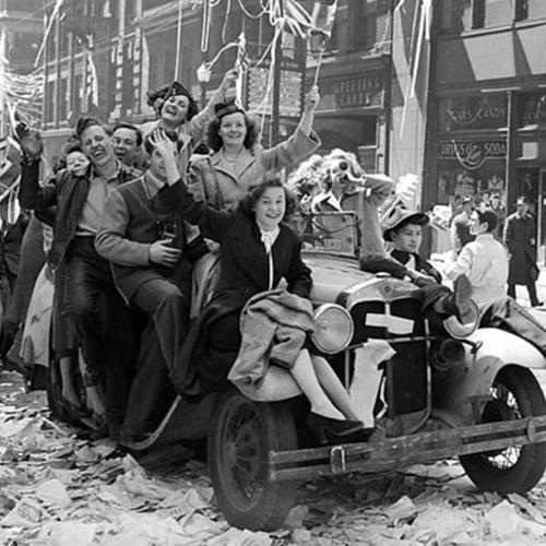 Black and white photo of a group of Canadians riding a car together at the time of the second world war